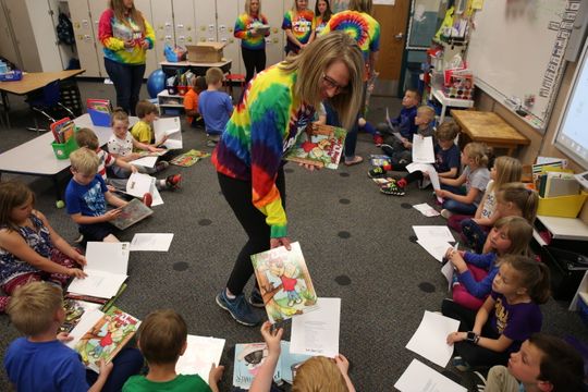 Olson, along with some of Cat's family members and friends, visited a classroom at Robert Frost Elementary School on Friday to surprise 23 first-graders in Dawn Sigl's class with new books.