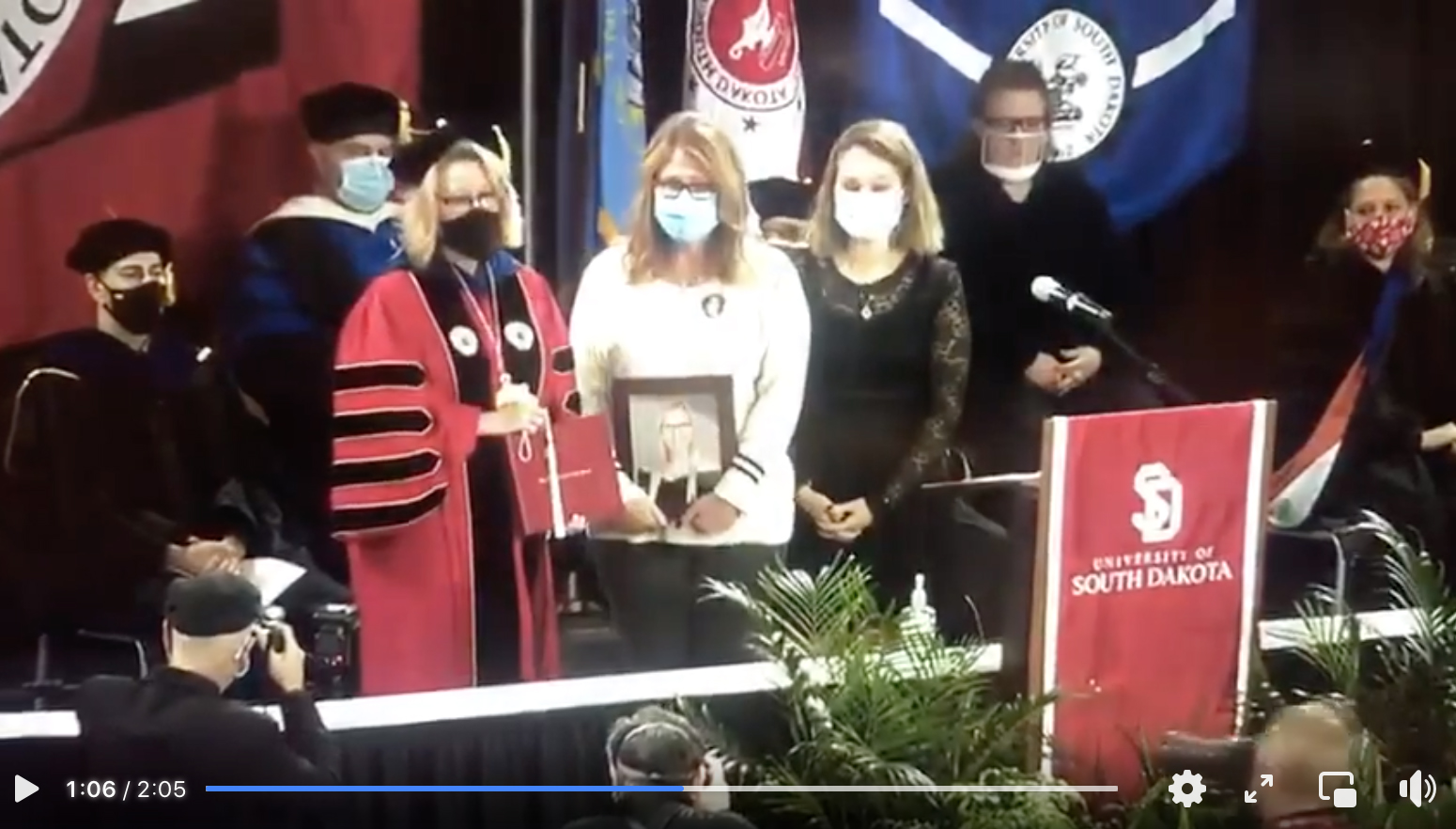 Barb and Alex accept Caitlyn's diploma at the 2020 University of South Dakota graduation